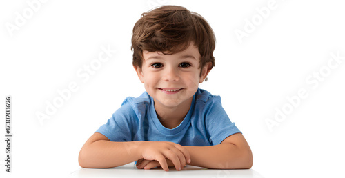 a cute boy sitting at the table, smiling. isolated on a transparent background.