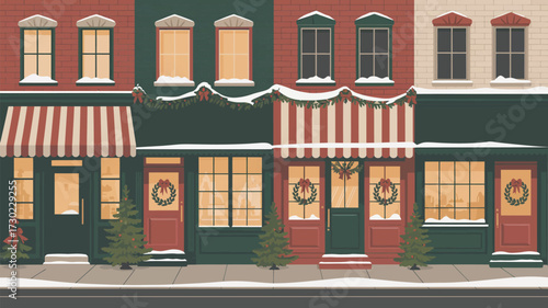 Festive storefronts decorated for christmas with wreaths and snow covered roofs on a winter day