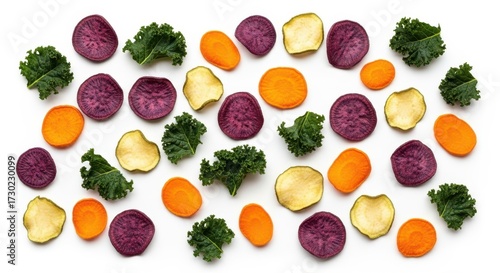Colorful vegetable chips and kale leaves on a white background flat lay