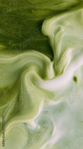 Close-up of matcha latte with swirling green tea and creamy milk. Abstract liquid texture creates a calming, minimalist composition, perfect for food photography, beverages, wellness, and lifestyle.