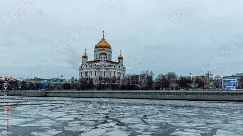 Hyperlapse of Moscow Cathedral across the river with illuminated domes and city reflections at night