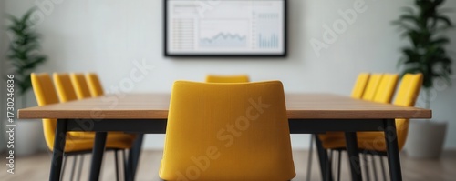 Stylish Conference Room with Yellow Chairs and Modern Presentation Screen Displaying Business Data and Insights in a Professional Setting