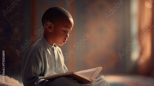 Young Muslim boy reading Quran in serene indoor environment  