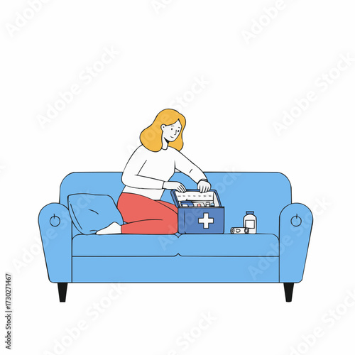 Woman opening first aid kit while sitting on blue couch at home  
