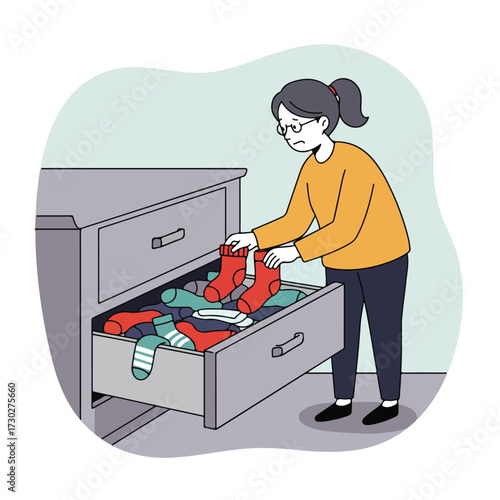 Woman sorts socks in a dresser drawer