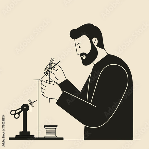 Man with beard fly tying at a table with a vise, thread, and materials
