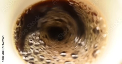 Close-up view of swirling coffee in cup, dynamic scene