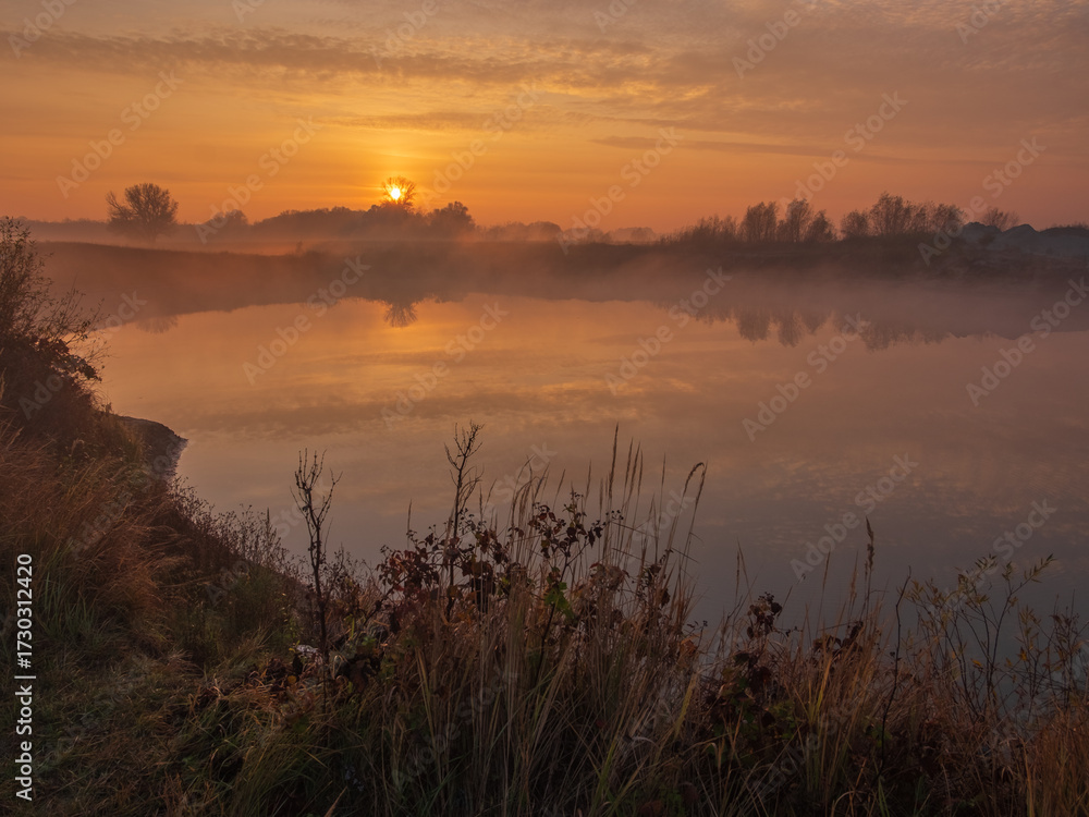 Fototapeta premium Misty sunrise over the river with fog 