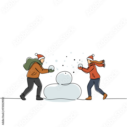 Couple having a snowball fight while playing outdoors in winter  