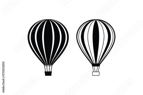 Two black and white striped hot air balloons floating in isolation