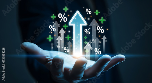 Businessman hand holding glowing upward arrows with percentage signs, business growth, profit increase, financial success and investment strategy concept
