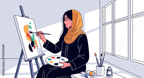 Woman in hijab painting abstract art on a canvas in a bright room.