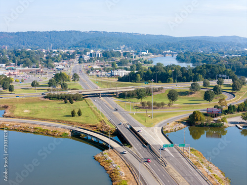 Wallpaper Mural Aerial View Of Bridge Over Coosa River, Interstate 759 and Highway 411, Lush Forest, And Distant Hillscape Under Clear Sky. The tranquil water reflects the blue sky, creating a scenic landscape. Torontodigital.ca