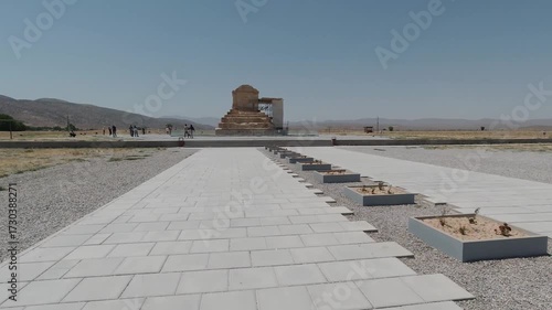 Wallpaper Mural Forward tracking shot approaching the Tomb of Cyrus the Great in Pasargadae, Iran. Iconic Achaemenid monument under clear blue sky, symbol of Persian history and UNESCO World Heritage. Torontodigital.ca