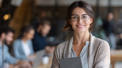 Confident Businesswoman Smiling with Tablet in Modern Office Environment