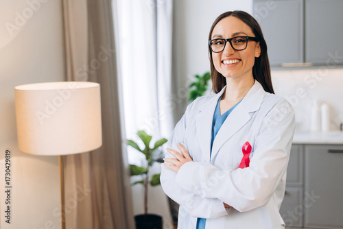 Doctor wearing pink ribbon raising breast cancer awareness