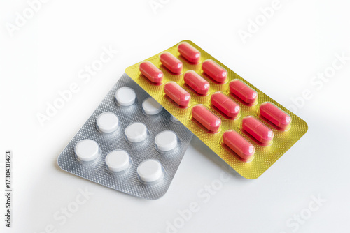 A rectangular blister packs of various-colored capsule pills on white background