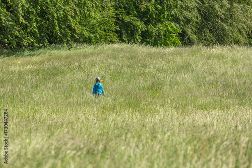 Girl running and jumping in a field