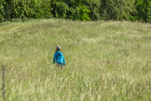 Girl running and jumping in a field