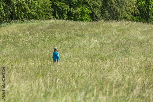 Girl running and jumping in a field