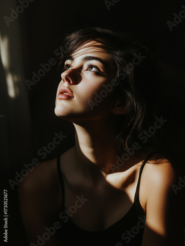 Cinematic chiaroscuro portrait with striking dramatic lighting, deep shadow contrast, and bold emotional presence, blending fine art and timeless visual storytelling