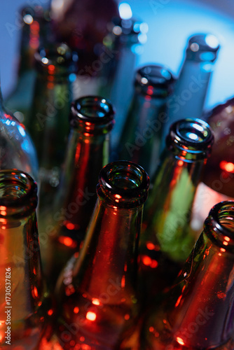 Close-up of Empty Glass Bottles with Colored Light at Night Party