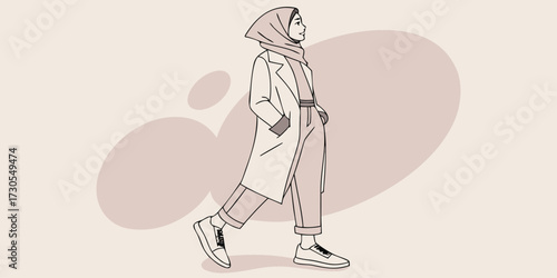 Stylish woman in hijab walking on the street