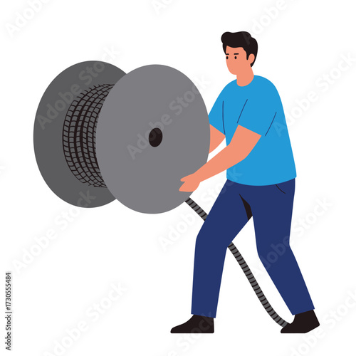 Man holding a large spool of cable, unwinding the wire.