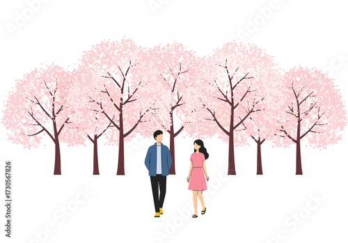 Couple walks in a grove of cherry trees with pink blossoms
