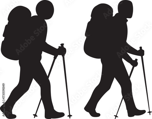 Two hikers with backpacks and trekking poles silhouette