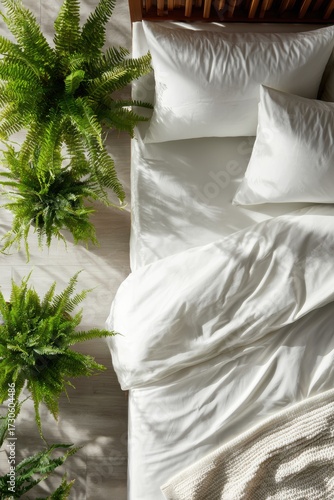 White percale sheets on mattress with knitted blanket, Boston fern and gray pillows, ash wood slats for modern mattress ads, vertical social media content, clean bedroom promotion