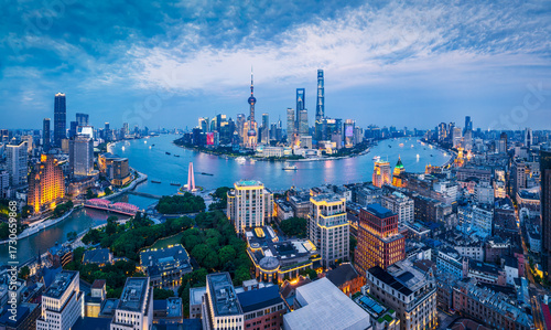 Photography Panoramic view of the Shanghai city skyline with the river and financial district skyscrapers at twilight