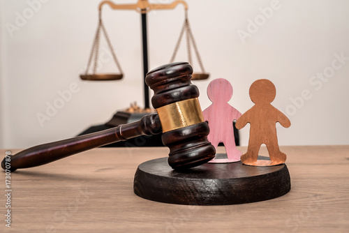 Bild auf Leinwand Judge's gavel, scales of justice, and two wooden figures symbolizing children, f