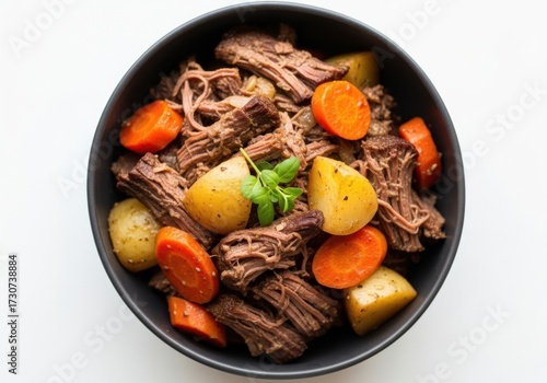 Overhead shot of pot roast with vegetables in bowl