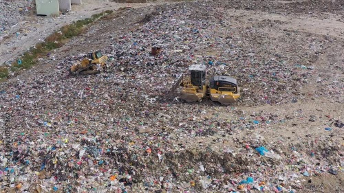 Aerial view of excavator working with trash on rubbish dump
