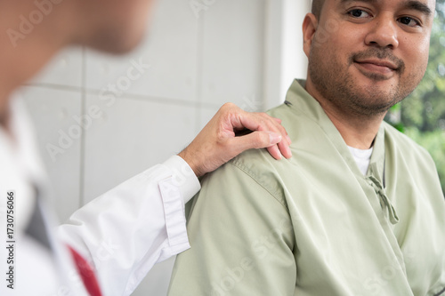 The doctor talks and encourages the patient about treatment options using a digital tablet, promoting clear communication and trust in a bright and supportive hospital environment.