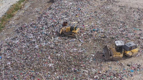 Aerial view of excavator working with trash on rubbish dump