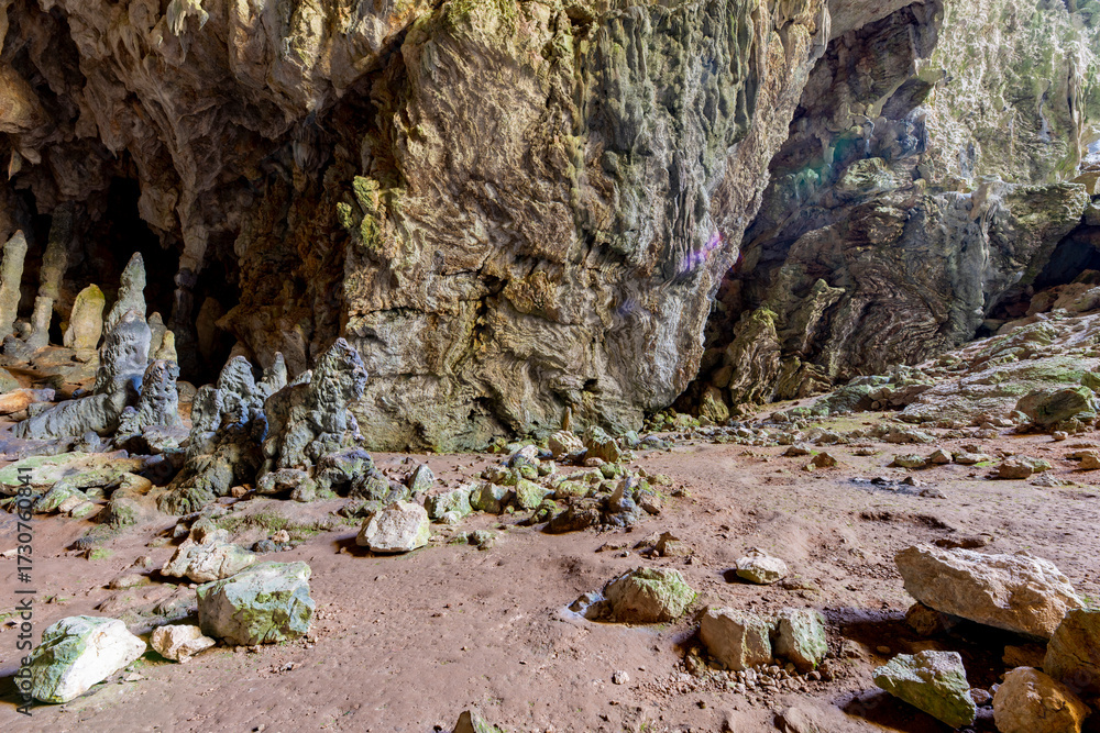 Obraz premium Nimara cave near Marmaris, Turkey inside. Stalactites stalagmites and streak formations in cave of Nimara Magarasi, Turkey. Stone walls and rocks in natural cave. stones covered with moss