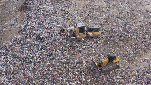 Aerial view of excavator working with trash on rubbish dump