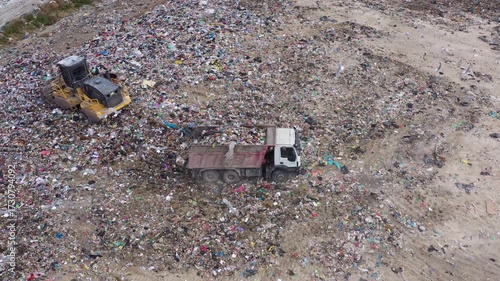 Aerial view of excavator working with trash on rubbish dump