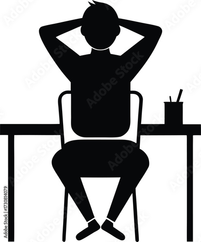 Man sitting at desk with hands behind head silhouette