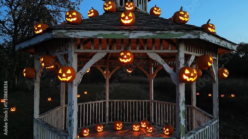 Glowing Jack-o'-Lanterns Light Up a Spooky Gazebo for Halloween Night, Creating a Festive and Eerie Atmosphere for Holiday Celebrations