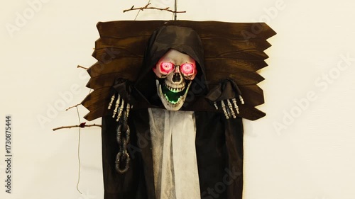 Spooky skeleton decoration with glowing eyes for Halloween party in a home setting