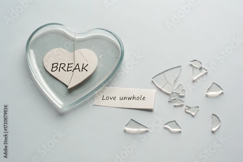 A broken heart made of glass with shattered pieces
