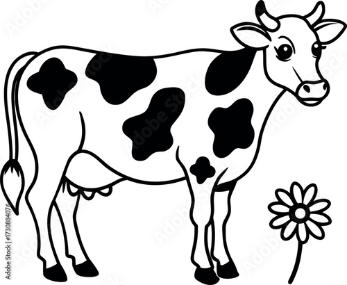 A spotted cow standing next to a flower