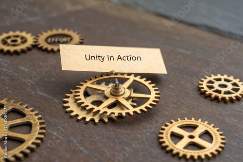 Brass gears assembling with card displaying unity in action