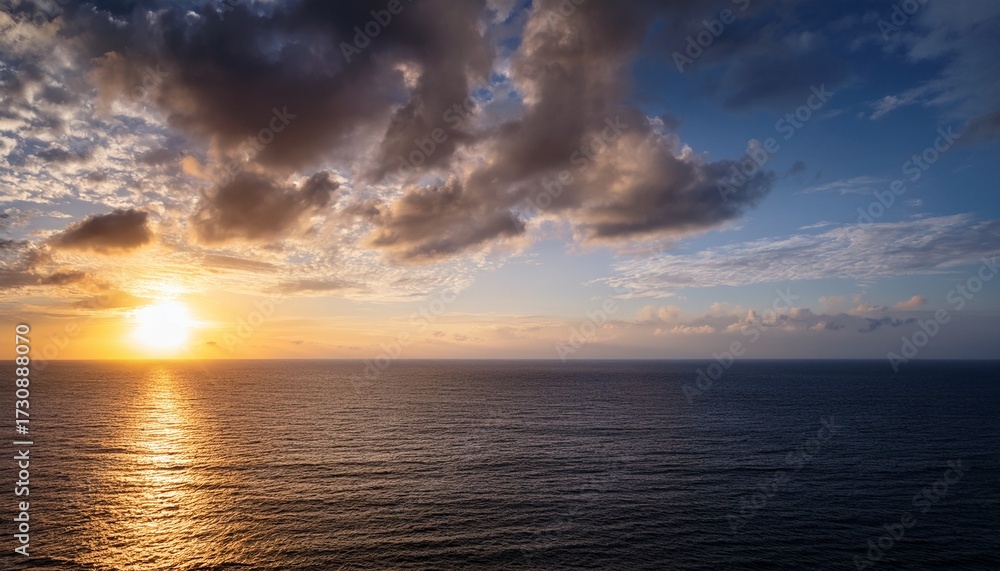 Naklejka premium Vast Ocean Expanse Under A Cloudy Sky At Dawn With A Hint Of Golden Sunlight On The Horizon