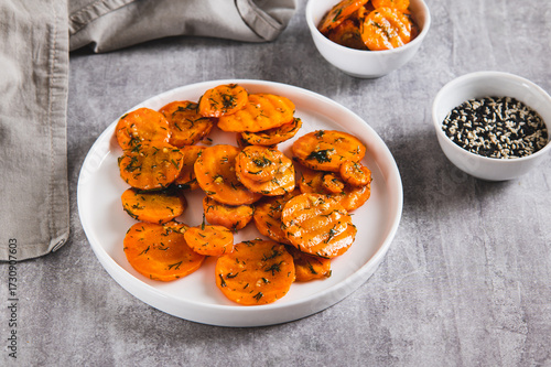 Fried carrots in spices and garlic on a plate on the table