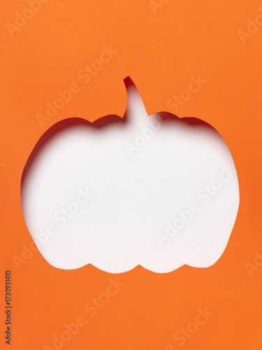 Orange pumpkin cutout with flying black bats.