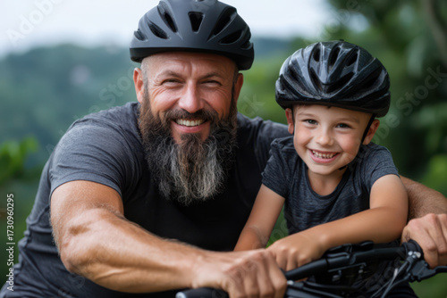 Portrait Father and son riding bicycles in the park during daylight hours